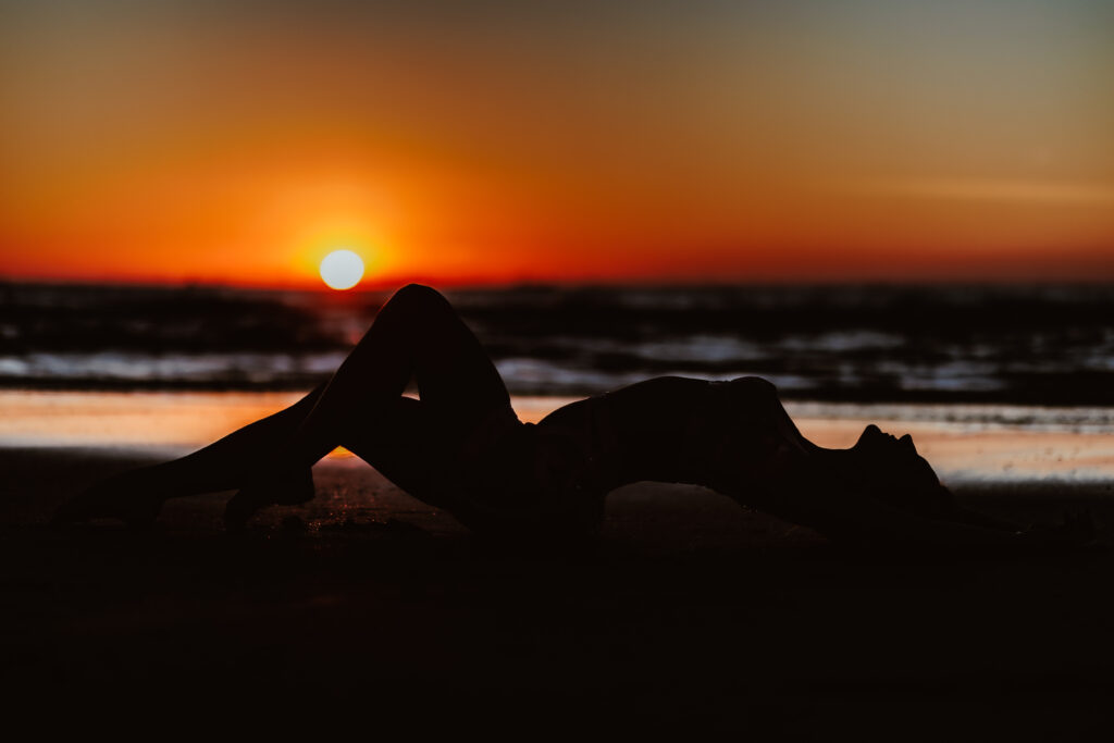 boudoir reportage op het strand bij avondlicht en de ondergaande zon